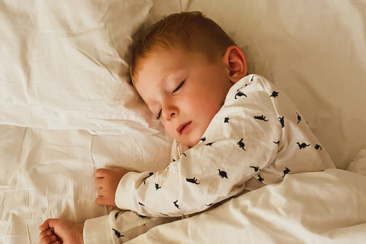 toddler sleeping peacefully in bed — safe bedtime toy guide